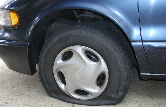 person with flat tire | Toyota of Orlando in Orlando FL